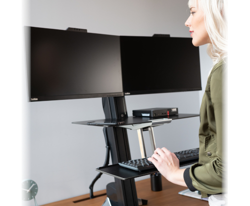 Ergotron WorkFit-S Dual, Black Colour, Front View, Office Usage, Raised Position, Person Typing